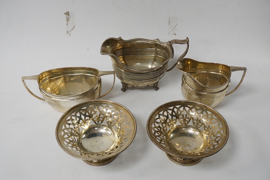 A George V silver milk jug and sugar bowl, by Barker Brothers Silver Ltd, Birmingham, 1931, a pair of silver bon-bon dishes and a silver milk jug, London, 1899, 22.7oz. Condition - poor to fair